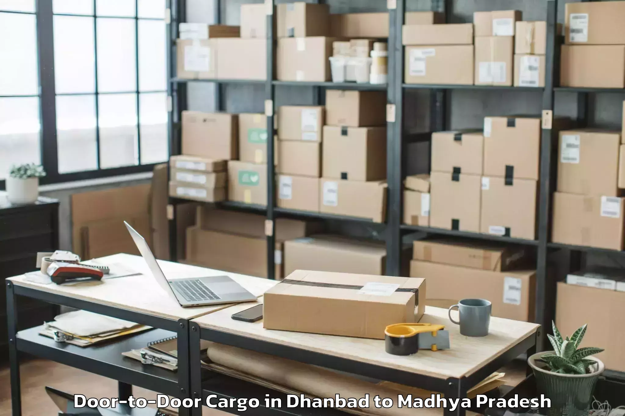 Book Dhanbad to Rajiv Gandhi Proudyogiki Vishw Door To Door Cargo Online